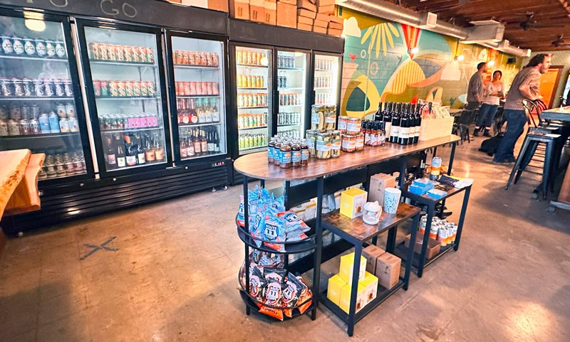 Interior of The Landing showing beer coolers, wine shelves and goods